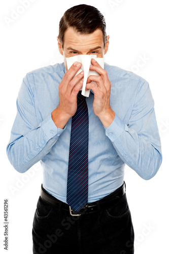 Photo: Young man having severe cold. Sneezing Young man having severe cold. Sneezing