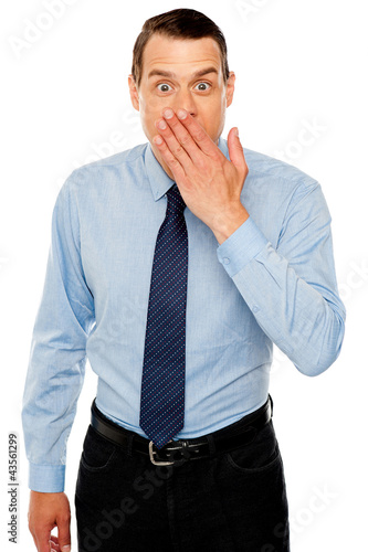 Photo: Surprised businessman with hand on mouth Surprised businessman with hand on mouth