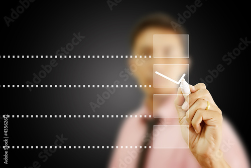 Photo: Businessman writing correct choice. Businessman writing correct choice.