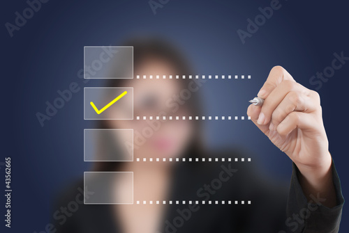 Photo: Business lady write correct choice. Business lady write correct choice.