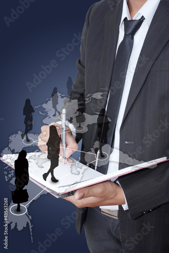Photo: Businessman writing on notebook with Social Network. Businessman writing on notebook with Social Network.