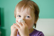 Little boy cleaning nose