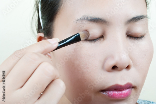 Photo: Close up Asian young woman make up. Close up Asian young woman make up.