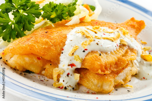 Photo: Fish dish - fried fish fillets and vegetable salad Fish dish - fried fish fillets and vegetable salad