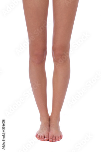 Photo: naked woman's legs are straight on white background naked woman's legs are straight on white background