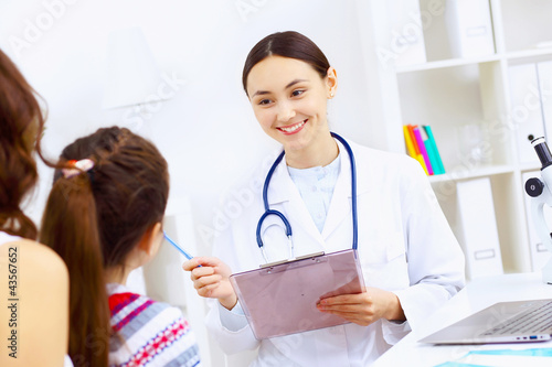 Photo: Little girl and a doctor Little girl and a doctor