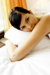 A lady lying on the bed comfortably