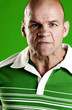 Man in green showing his angry face