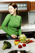 Woman cutting vegetables in the kitchen