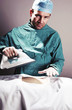 Man in surgeon outfit ironing clothes