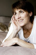 Woman lying on the bed thinking