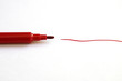 Red marker pen with scribble on paper
