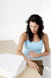 Hungry woman looking at boxes of pizza