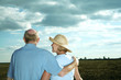 Senior couple enjoying beautiful field scenery
