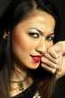 Photo: Woman rubbing off her lipstick with her hand Woman rubbing off her lipstick with her hand