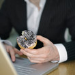 Guy eating doughnut while using laptop