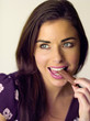 Woman eating a chocolate finger