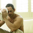 A man resting and thinking after working out