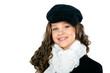 A little beautiful girl is in autumn clothes on a white 