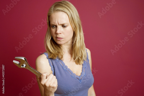 Photo: Woman holding an adjustable spanner Woman holding an adjustable spanner