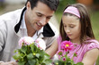 Man and girl planting flowers