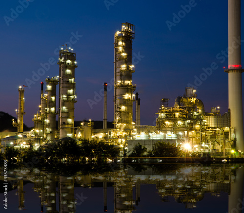 Photo: Petrochemical industry on sunset dark blue sky. Petrochemical industry on sunset dark blue sky.