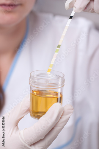 Photo: Woman making urine test Woman making urine test