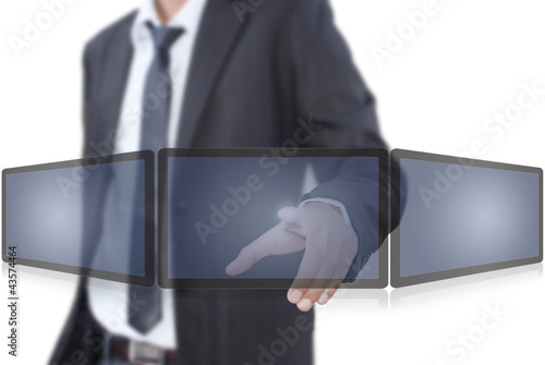 Photo: Businessman pushing on tablet screen. Businessman pushing on tablet screen.