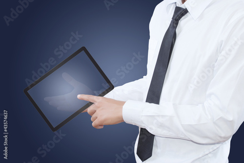 Photo: businessman pushing tablet screen in hand.. businessman pushing tablet screen in hand..