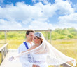 Photo: Couple in wedding day with wind on veil Couple in wedding day with wind on veil