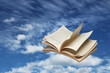 Photo: Open book flying on blue sky Open book flying on blue sky