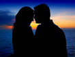 Photo: Couple in love hug in suset on sea Couple in love hug in suset on sea