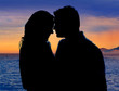 Photo: Couple in love hug in suset on sea Couple in love hug in suset on sea