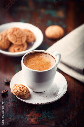 Photo: Cup of espresso and biscotti on dark wooden table Cup of espresso and biscotti on dark wooden table