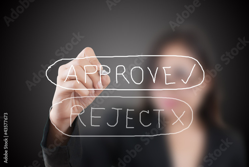 Photo: Business woman writing approve word. Business woman writing approve word.