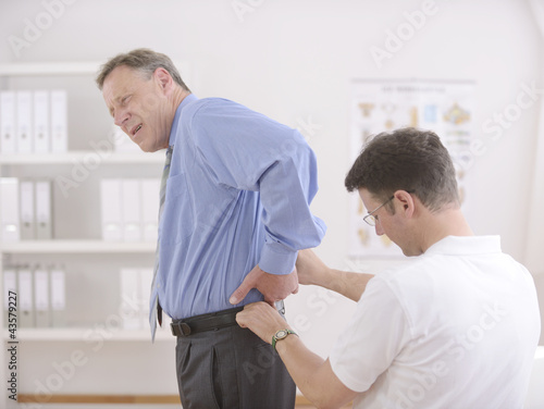 Photo: Physiotherapy: Physiotherapist examining senior man Physiotherapy: Physiotherapist examining senior man