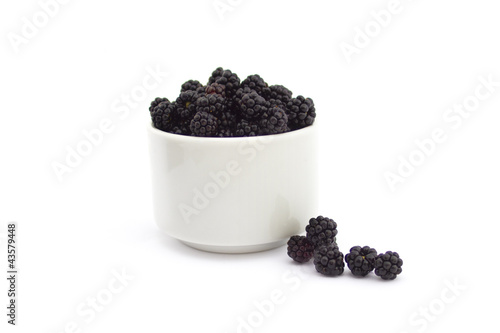 Photo: Cup of blackberries isolated on white Cup of blackberries isolated on white