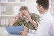 Photo: Doctor showing results to myopic patient Doctor showing results to myopic patient