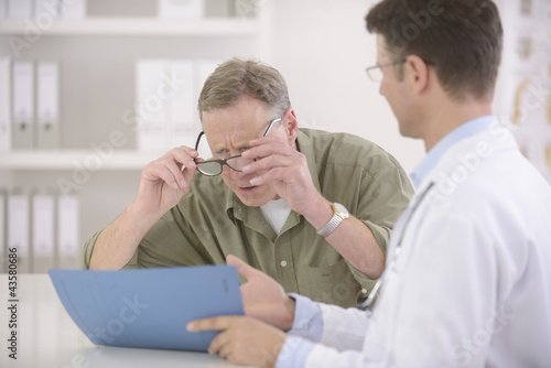 Photo: Doctor showing results to myopic patient Doctor showing results to myopic patient