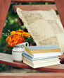 Books, and marigolds in a vase stock image