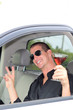 Man In Truck Holding Alcohol Causally Laughing