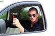 Man In Truck Holding Alcohol Smiling
