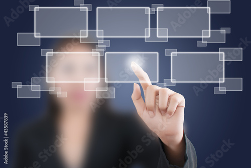 Photo: Business lady pushing button on the whiteboard. Business lady pushing button on the whiteboard.