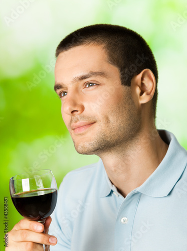 Photo: Thinking man with redwine, outdoors Thinking man with redwine, outdoors