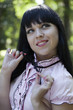 Portrait of the beautiful young brunette in park