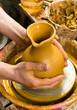hands of a potter, creating an earthen jar on the circle