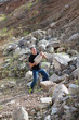 Photo: the man picks up a stone on the career the man picks up a stone on the career