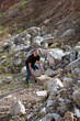Photo: the man picks up a stone on the career the man picks up a stone on the career