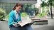 Video: Woman reading newspaper in the city Woman reading newspaper in the city