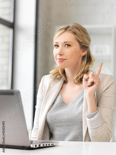 Photo: woman with laptop and finger up woman with laptop and finger up